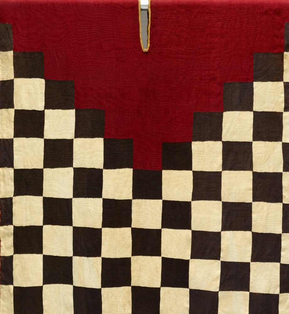 Tunic with checkerboard pattern and stepped yoke_1995.32.McD