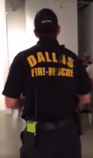 Screen shot of Dallas Fire-Rescue officer walking through Art Con event at Kirk Hopper Fine art. 