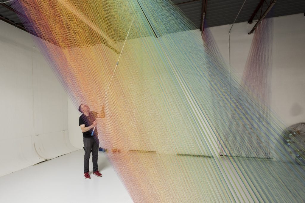 Artist Gabriel Dawe creating one of his threaded scultures. Photo: Amon Carter Museum of American Art