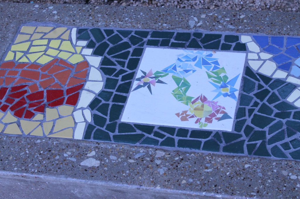 The mosaics on the bench illustrate the seasons: this is spring, and the three flowers represent the three forks of the Trinity River. Photo: Francesca Paris