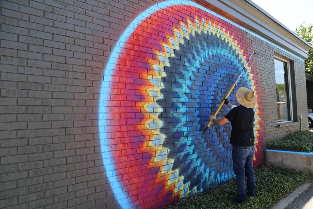Miami artist Douglas Hoekzema painting a mural in front of Fort Works Art. Photo: Hady Mawajdeh