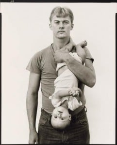 John Harrison holds his daughter Melissa upside down and by her legs in the Avedon photograph