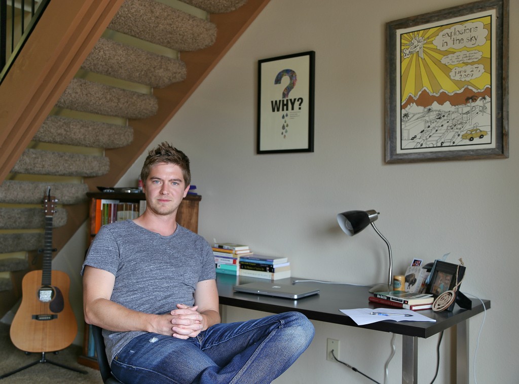 Poet Matt Morton sitting at his desk in his Denton apartment. Photo: Hady Mawajdeh