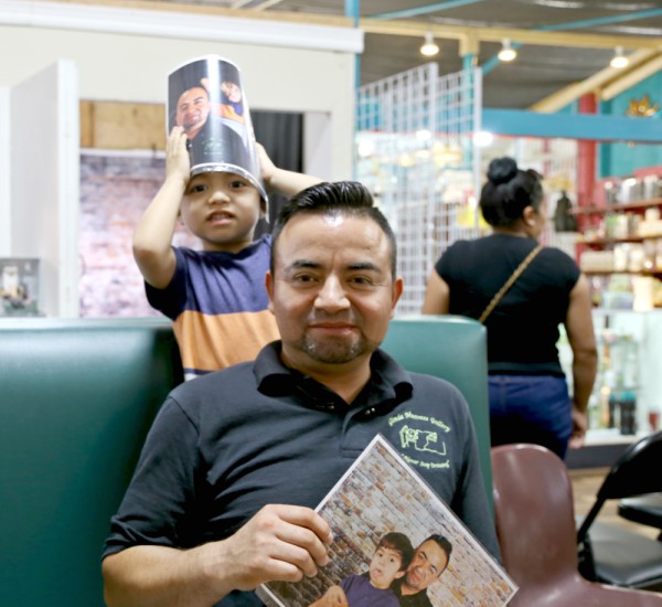 Jose Pineda and his son say they're happy about the photos Reyes has taken of them. Photo: Hady Mawajdeh