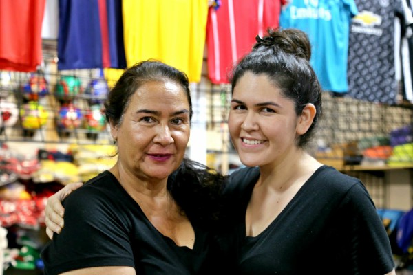 Alma Guzman (right) and her mother pose near Reyes' studio in Latina Plaza. Photo: Hady Mawajdeh