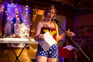 Donned in a Wonder Woman costume, Bonnie Jo Stufflebeam reads to the crowd. Photo: Leah Jones