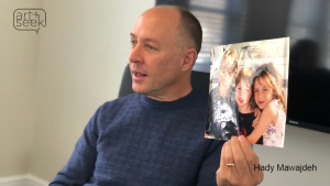 Mark Barden holds a photo of his three children as he tells the cast of Cry Havoc about the day his son was killed in Sandy Hook Elementary. Photo: Hady Mawajdeh