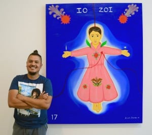 Armando Sebastian with his self-portrait, “Mexican Pink,” featured in the art show "MaricónX" at the Latino Cultural Center in July. Photo: Olivia Peregrino