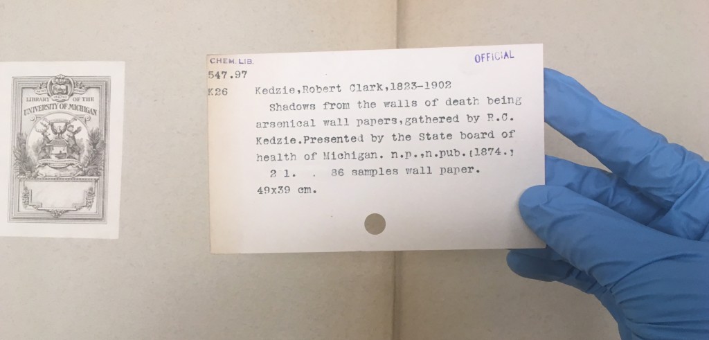 Greene's gloved hand holds a warning note from Dr. Robert M. Kedzie. The warning note reads: "Shadows from the walls of death being arsenical wall papers, gathered by R.C. Kedzie. Presented by the State board of health of Michigan." Photo: Courtesy Kendra Greene 