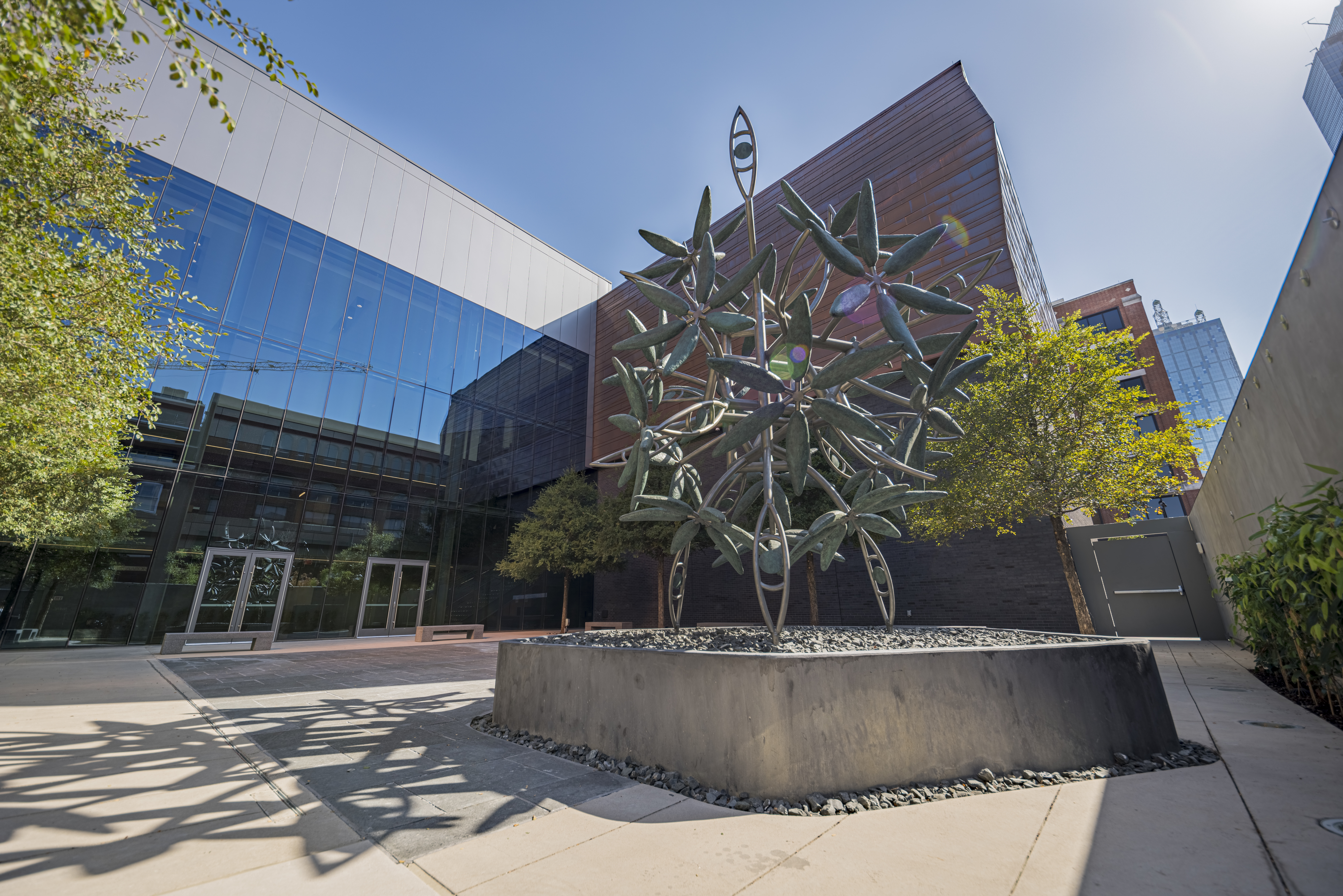 This Place, Everywhere (2019), a sculpture created by Texas artist James Surls. The sculpture’s six-petal flowers represent the six million Jews murdered during the Holocaust. The sculpture’s eighteen flowers represent Chai, the Hebrew word for life. Eighteen eyes are also interspersed throughout the sculpture, either looking down at the past and what was lost, or upwards to envision better lives for future generations. Photo: Courtesy Dallas Holocaust and Human Rights Museum