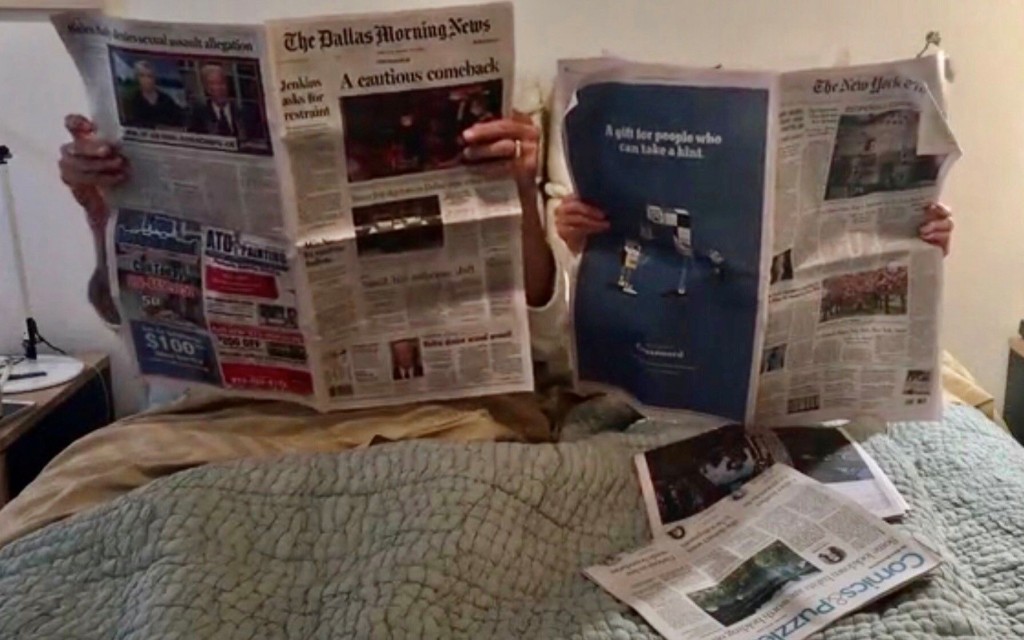 Joan Davidow and Stuart Glass read the morning newspaper in bed. 