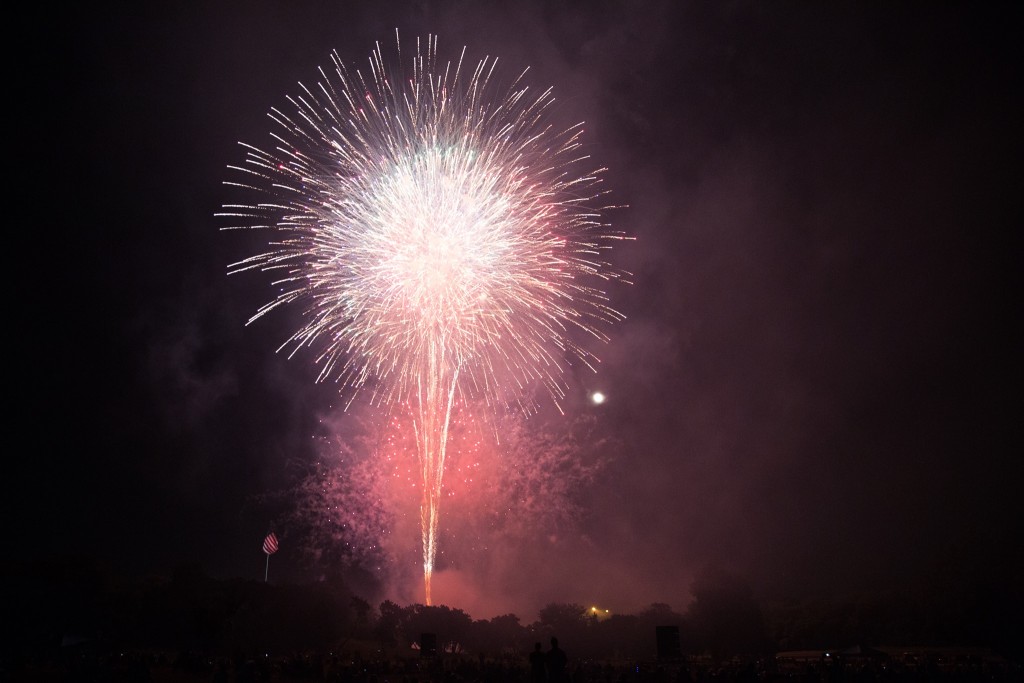 A single large burst of fireworks sparks in a dark sky. 